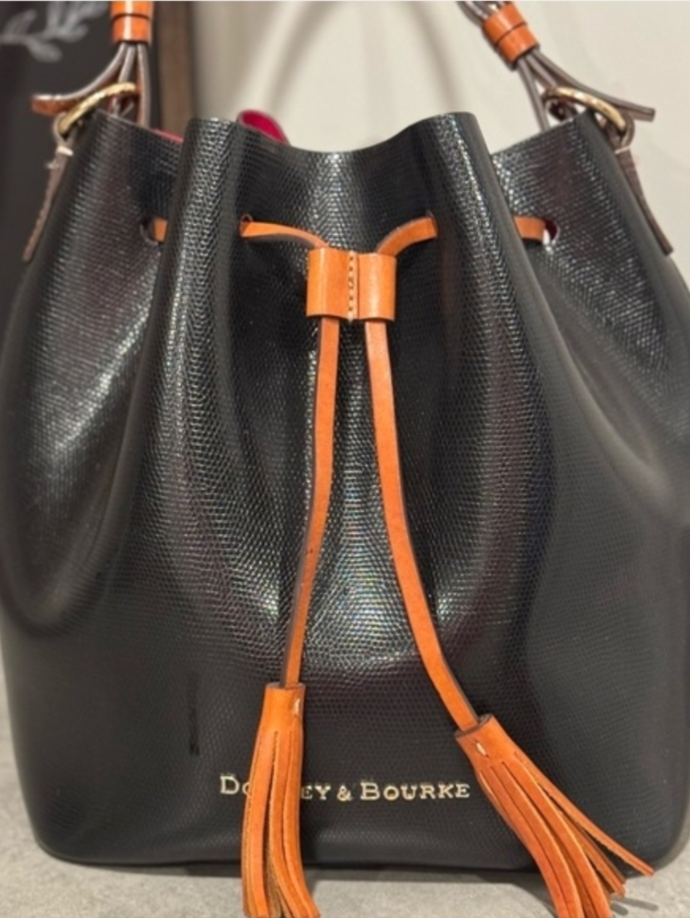 Dooney & Bourke Black Leather Shoulder Bag with Orange Tassel and Pink Lining